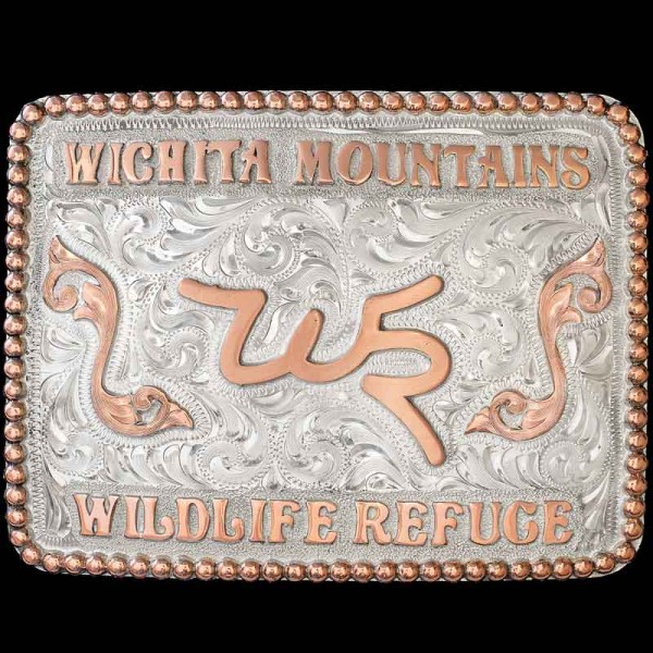 "This stunnin' belt buckle is the perfect design for simple customizations like your ranch brand, company logo, name and more. The Indiahoma Custom Buckle is crafted on a hand engraved, German Silver base. It's detailed with a beaded Copper border, l